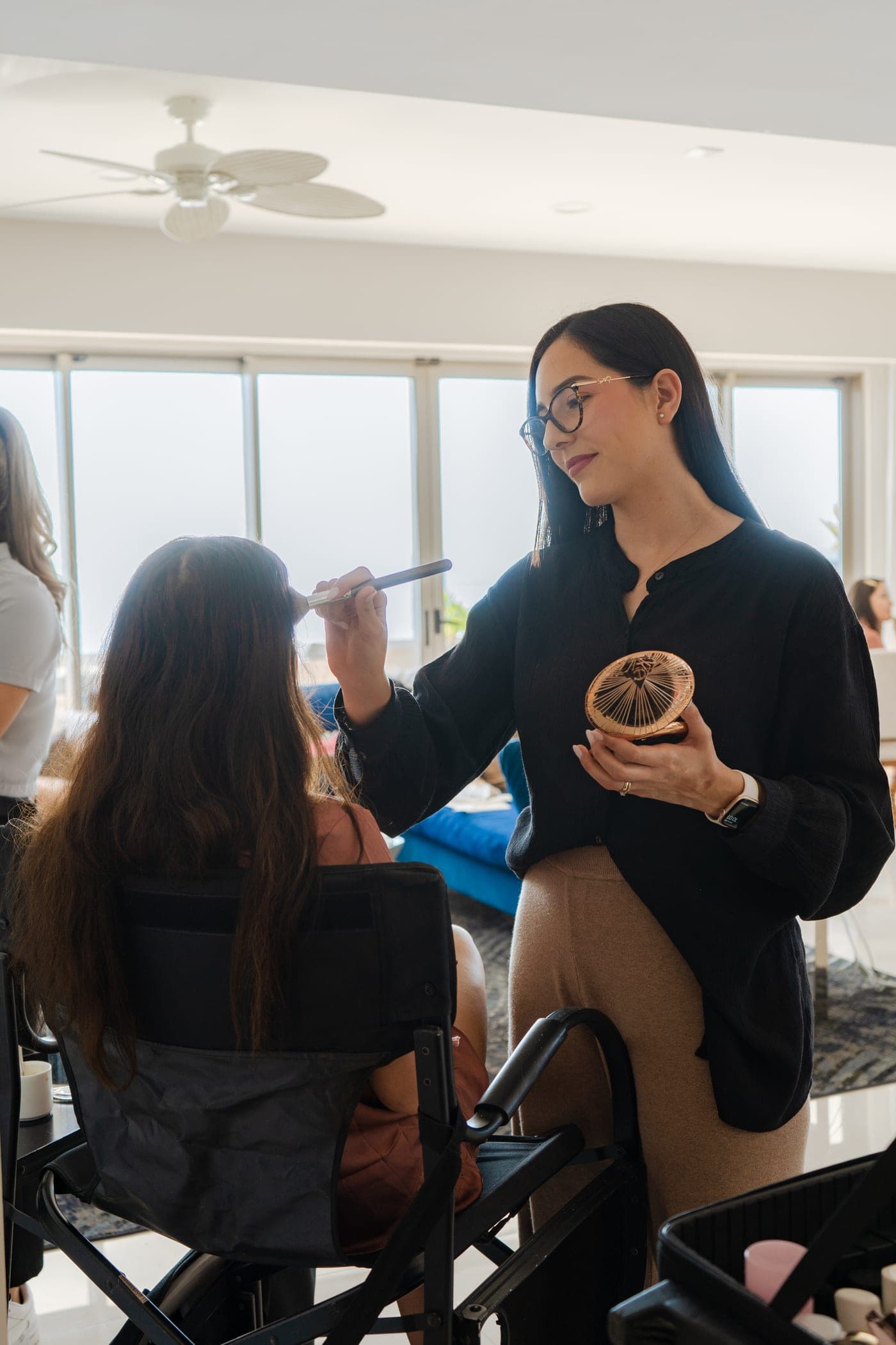 Artista de Mich & Beauty aplicando maquillaje ligero con brocha durante el getting ready